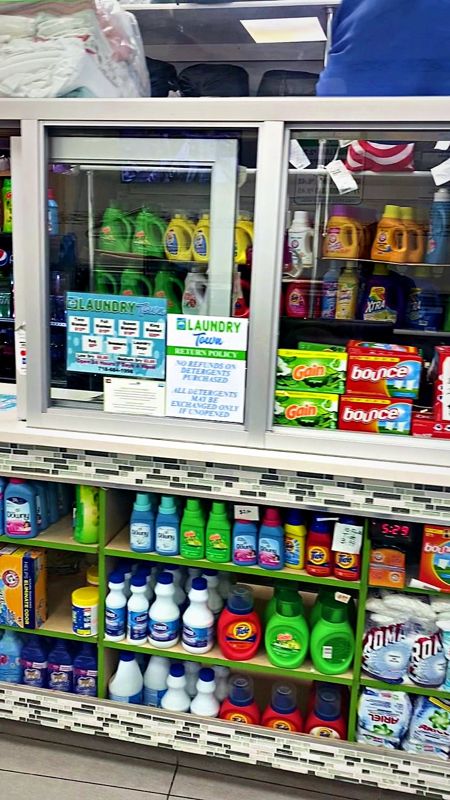 Shelves of detergent, softener and dryer sheets